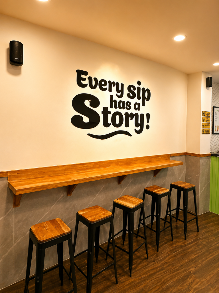 Dining area inside Chai Kings Ameerpet with bar seating, wooden counters, and “Every Sip Has a Story” wall art.