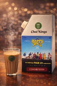 Chai Kings takeaway flask with MAR 27 movie poster and paper cup placed on a table inside a tea outlet, showcasing branded movie promotion packaging.
