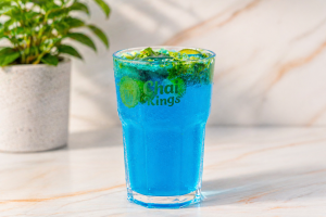 Chai Kings Ocean Blue Mojito served with fresh mint leaves and lemon