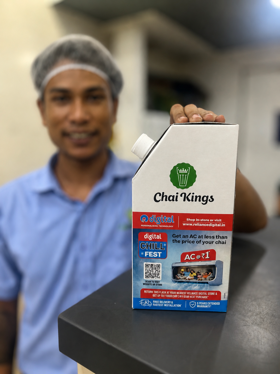 Chai Kings staff member presenting the Reliance Digital Chill Fest flask