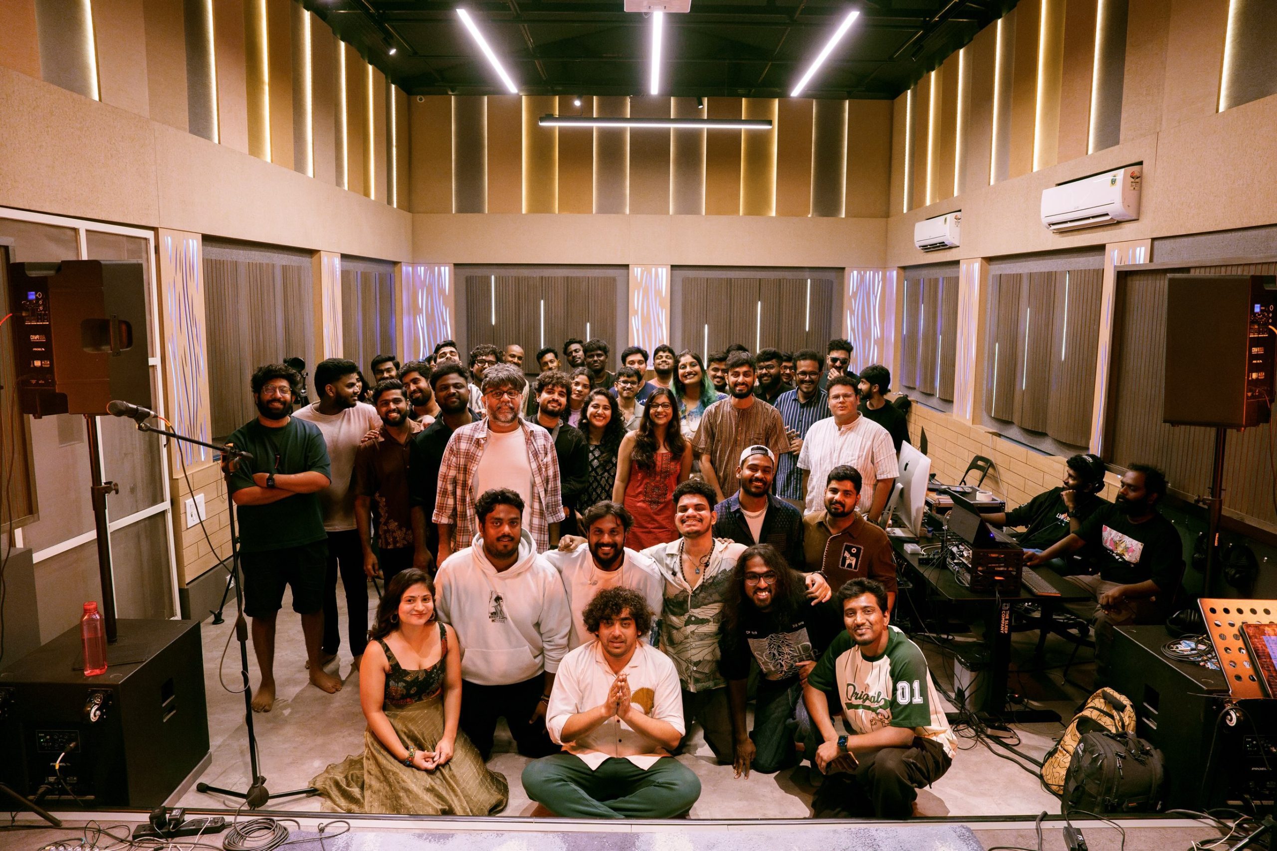 Indie band and audience group photo at Aura Studios after the show