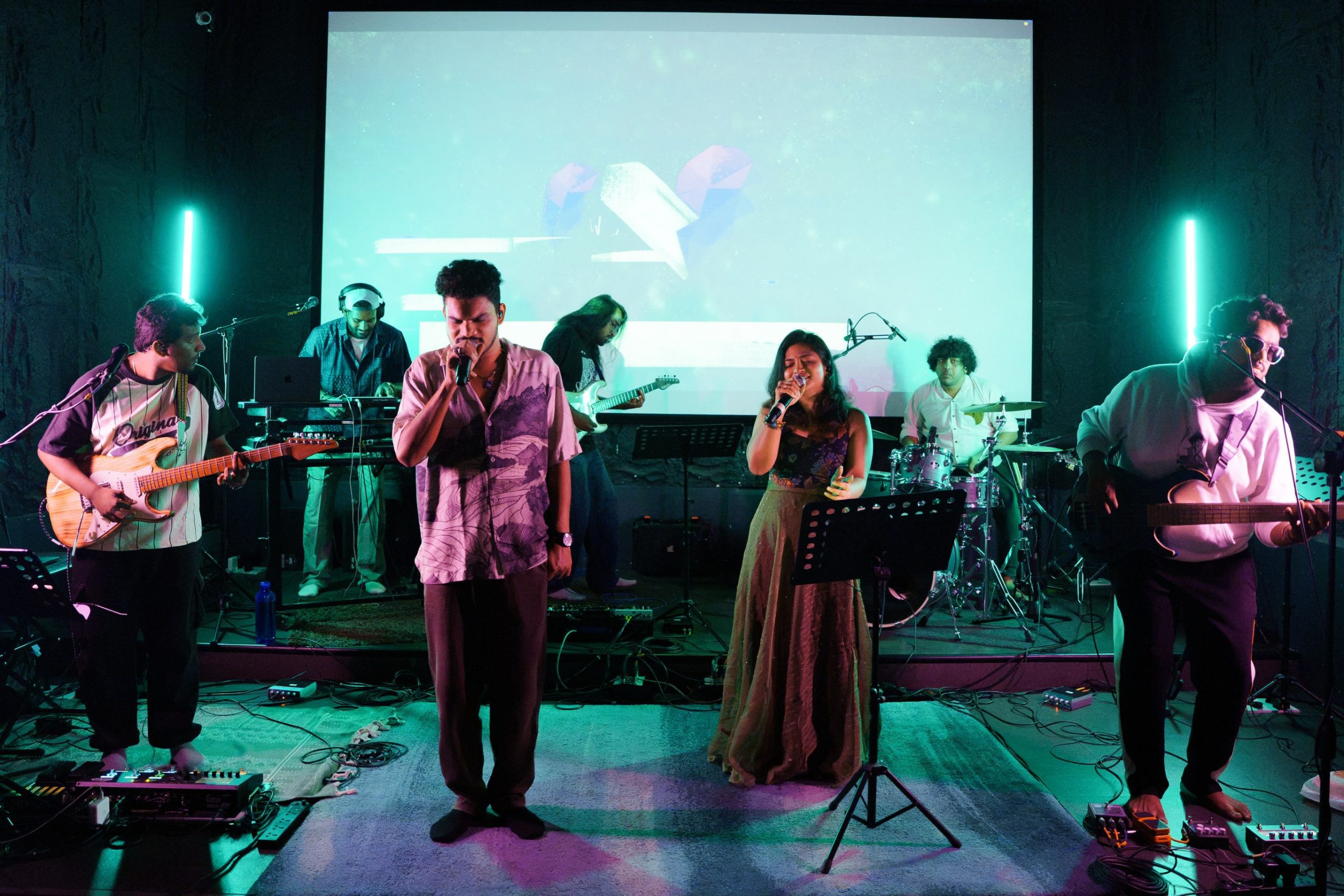 Indie music band performing live on stage at Aura Studios