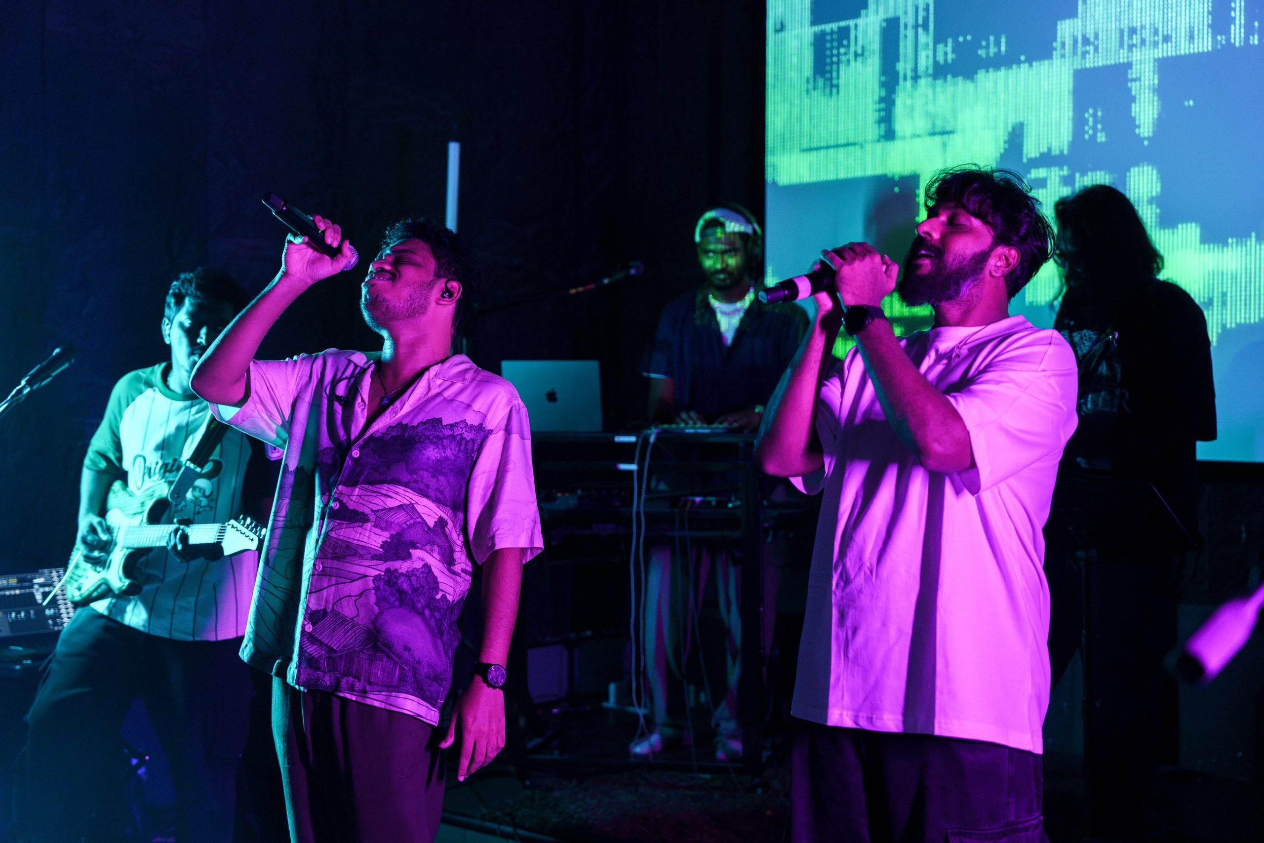 Singers performing a duet under stage lighting at the Chai Kings Studio Indie Music Festival
