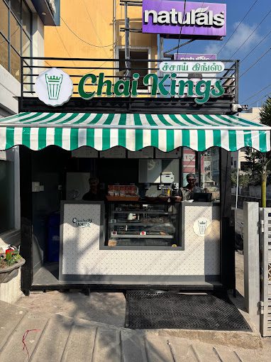 Front counter of Chai Kings tea cafe in Madipakkam displaying snacks and tea options